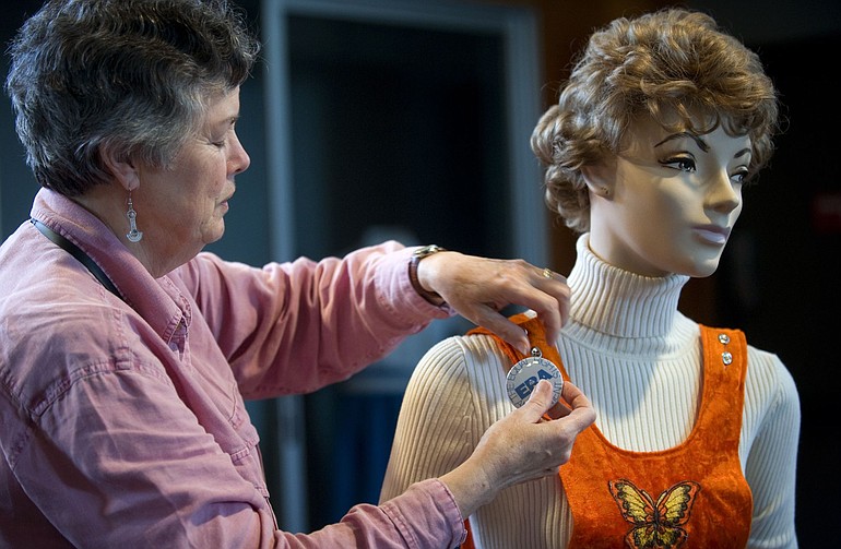 Eileen Fitzsimons dresses a mannequin for the new exhibit at the Clark County Historical Museum, &quot;Road to Equality: The Struggle for Women's Rights in the Northwest.&quot; The exhibit spans 1848 to the late 1970s and covers issues such as suffrage -- Washington women won the right to vote twice and had it taken away before the 1910 change that's still in effect -- &quot;men's work,&quot; and the Civil Rights movement.