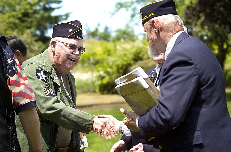 Will Hayden, left, a Korean War veteran, receives a plaque honoring his service Friday from the Rev. Jerry Keesee, American Legion chaplain. From June 25, 1950, to July 27, 1953, the U.S.