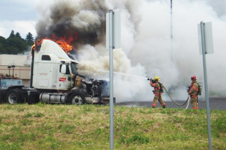 Firefighters douse flames that destroyed a truck tractor worth $30,000 at Frito-Lay on Northwest Fruit Valley Road on Monday afternoon.