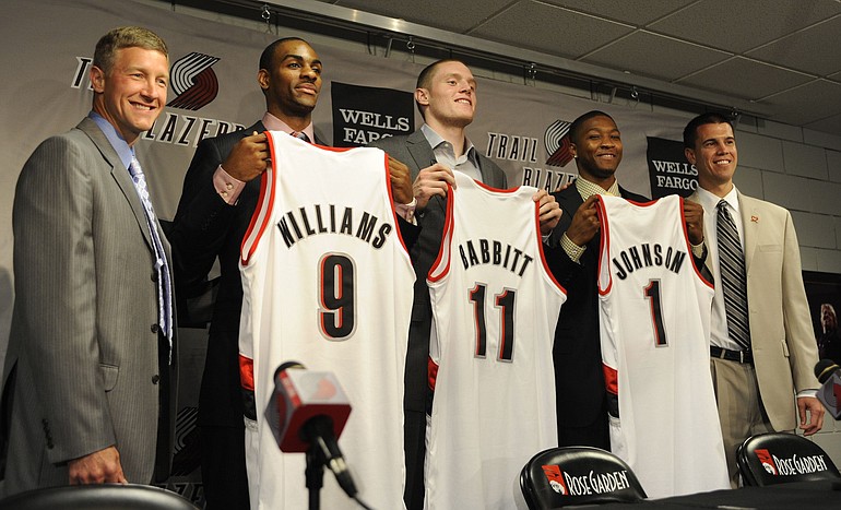 New Portland Trail Blazers, from second left, Elliot Williams, Luke Babbitt and Armon Johnson, hold up their new jerseys as they stand with NBA scout Michael Born, left, and college scout Chad Buchanan, right, during a press conference Monday in Portland.