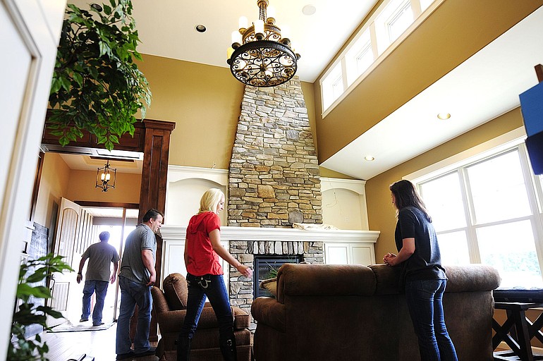 Kelly Helmes, vice president of New Tradition Homes, from left, Laura Bellcoff, marketing manager, and Jerai Laird, interior designer, set up the company's 2010 Clark County Parade of Homes display house, The Winlock.
