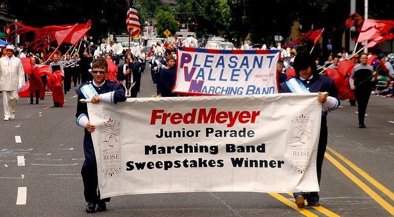 Battle Ground: Chase Lund, left, and Melissa Huynh carry the Pleasant Valley Middle School marching band banner in the 2010 Rose Festival Fred Meyer Junior Parade.