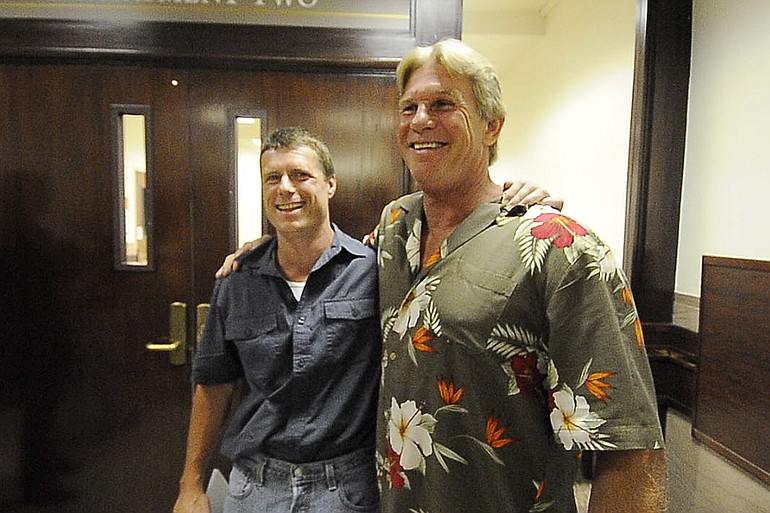 Alan Northrop, left, and Larry Davis celebrate this morning outside a Clark County courtroom after a Superior Court judge dismissed charges against them in a 1993 rape conviction on the basis of new DNA evidence that pointed to different assailants.