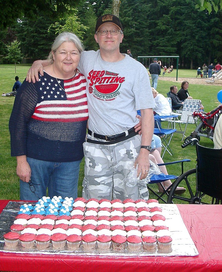 Airport Green: Judy Perry and Dave Schwarzott pose in front of a patriotic arrangement of cupcakes on July 3.