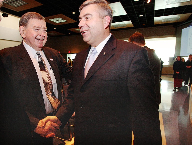 Royce Pollard, left, shakes hands with Clark College President Bob Knight after Knight's annual State of the College speech in January 2009.