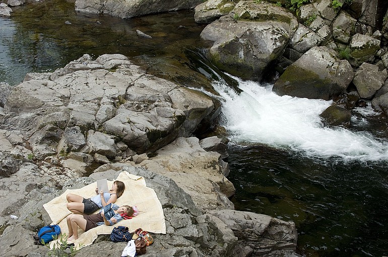 Sunbathers relax at Lower Dougan Falls on Wednesday, where Kea Rodrigues' leg became trapped in the rocks in the pool under the waterfall on July 9.
