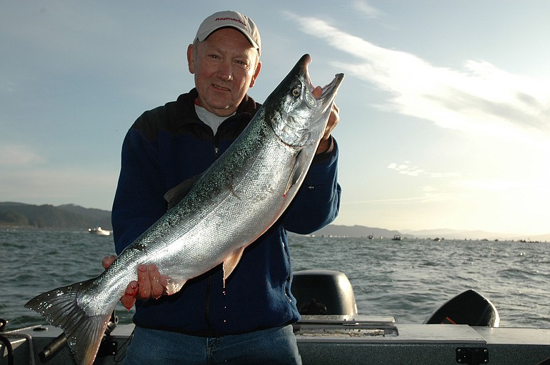 Dick Borneman of Vancouver holds a coho caught upstream of the Megler-Astoria Bridge in the Buoy 10 salmon season in 2009.