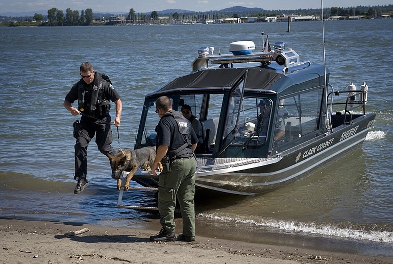 Battle Ground Police Officer Brian Archer and his tracking dog, Halo, exit a Clark County Sheriff's boat during a recent training session at Marine Park.