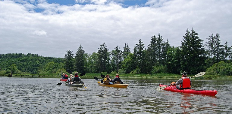 Kayakers and canoers paddle on the Lewis and Clark River in Oregon, near where the explorers spent the winter of 1805-06.