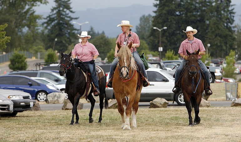 Members of the fence riders on patrol at the fair, from left: Stephenie Strong on Lexi, Samantha Anderson on Penny, and Bill Delepierre on Bubba.