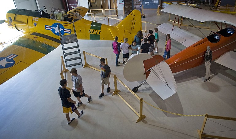 Children attending aviation camp at Pearson Air Museum get close-up looks at a restored 1943 AT-6, left, and a 1931 Consolidated Fleet.