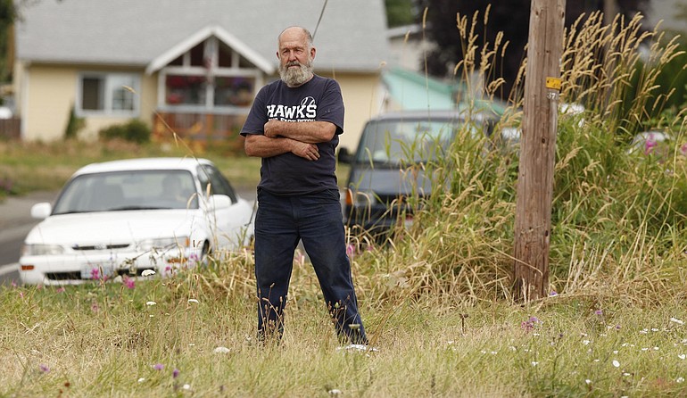 Ernie Foster, standing at the grassy swath where Northeast St. James and St.