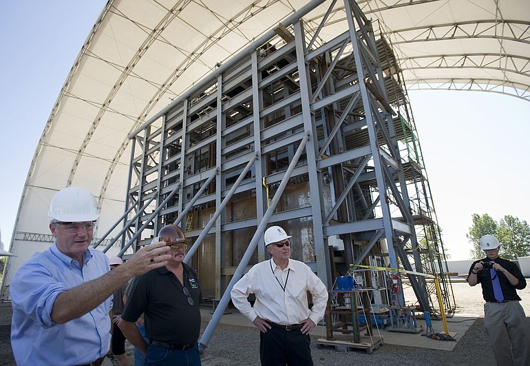 Congressman Brian Baird, left, stands before a nuclear shield door made at Oregon Iron Works in Vancouver.