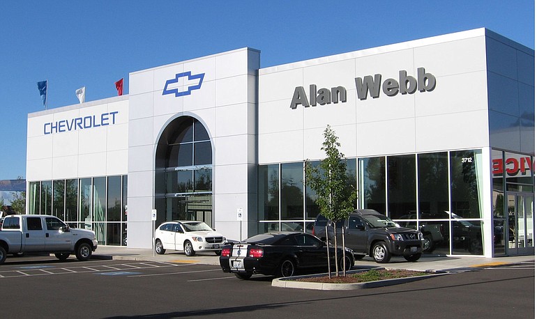 Vancouver auto dealer Alan Webb has added Chevrolet to his stable of brands. His new showroom is at 3712 N.E. 66th Ave. Top: Workers from Vancouver Sign Co.