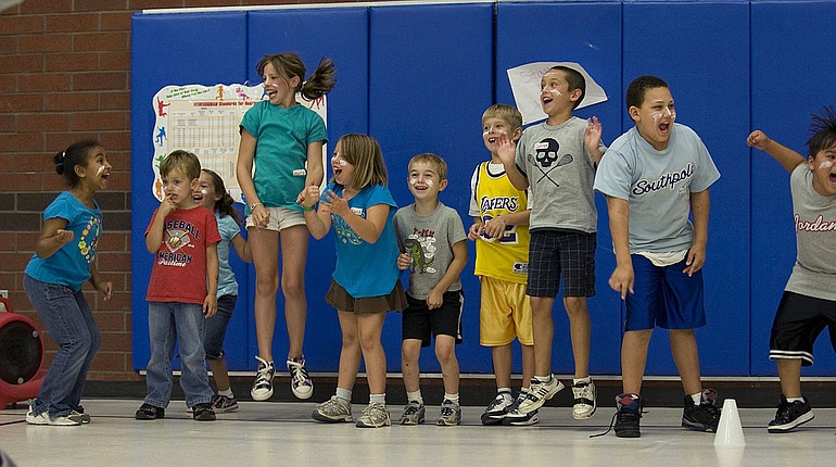 Children jump with excitement when given a chance to throw balls at their counselors.