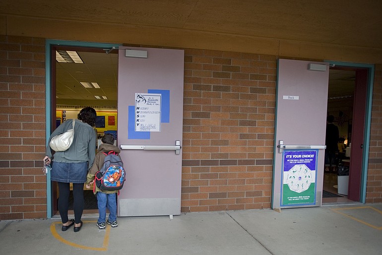 Kinuyo Endres of Vancouver looks for the correct kindergarten classroom for her son Anthony, 5, during the first day of school at Harmony Elementary on Wednesday. With sweaty palms and her heart pounding, Endres admitted that she was much more nervous than her son.