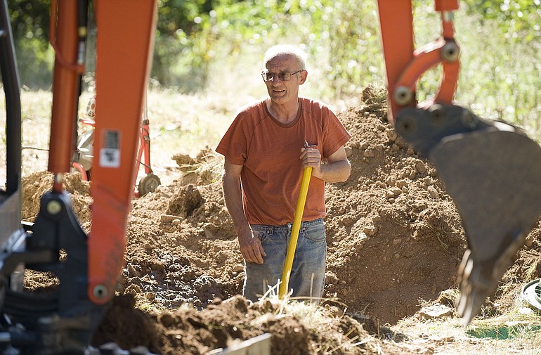 Dale Waliezer, owner of AAA Septic Service, works on the septic system of a house in Washougal.