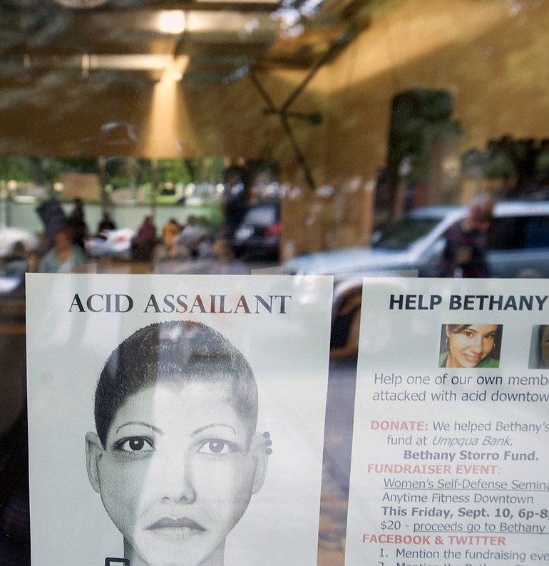 A flier depicting an alleged assailant in an acid attack -- now revealed as a fake -- hung in the window of Anytime Fitness in downtown Vancouver on Sept.