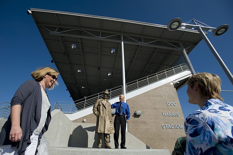 Doreen McKercher, from left, Doug Quinn and Heidi Rosenberg check out a new statue of Doc Harris at the newly remodeled Doc Harris Stadium in Camas.