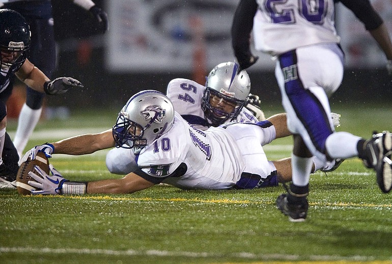 Heritage's Andy Bemis (10) recovers a fumble against Skyview in the first half at Kiggins Bowl on Friday.
