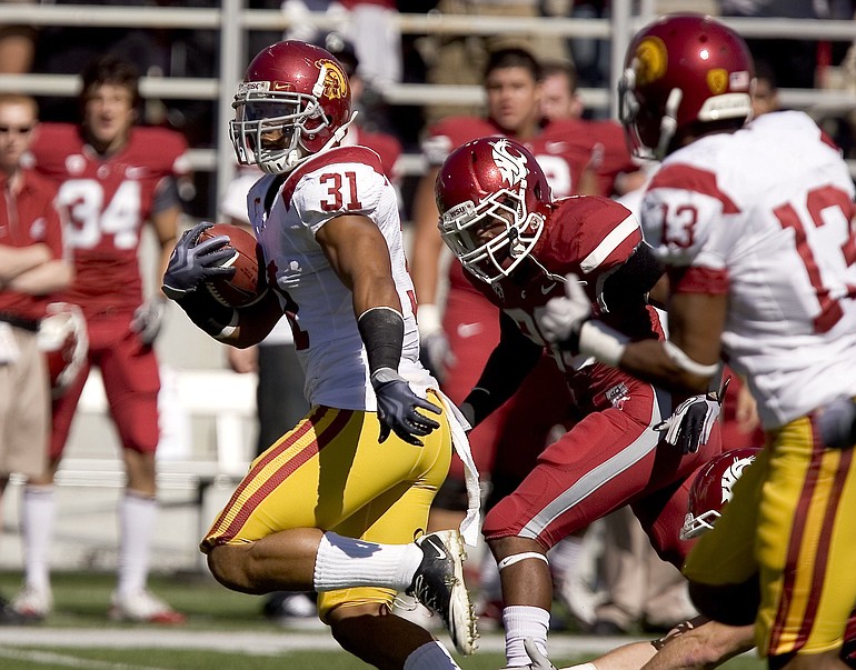 Southern California fullback Stanley Havili (31) outruns Washington State safety Tyree Toomer, center, as he scores a touchdown on USC's first play from scrimmage Saturday.