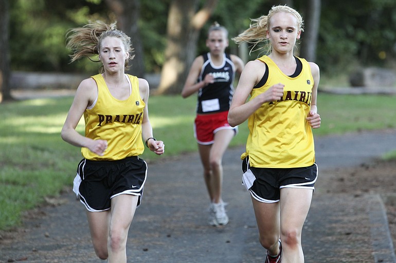 Lindsay Tompkins, left, and Taylor Guenther work together in training and on the course to improve their running.