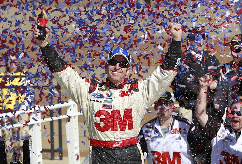 Greg Biffle celebrates in victory lane after winning the NASCAR Sprint Cup Series auto race at Kansas Speedway on Sunday.