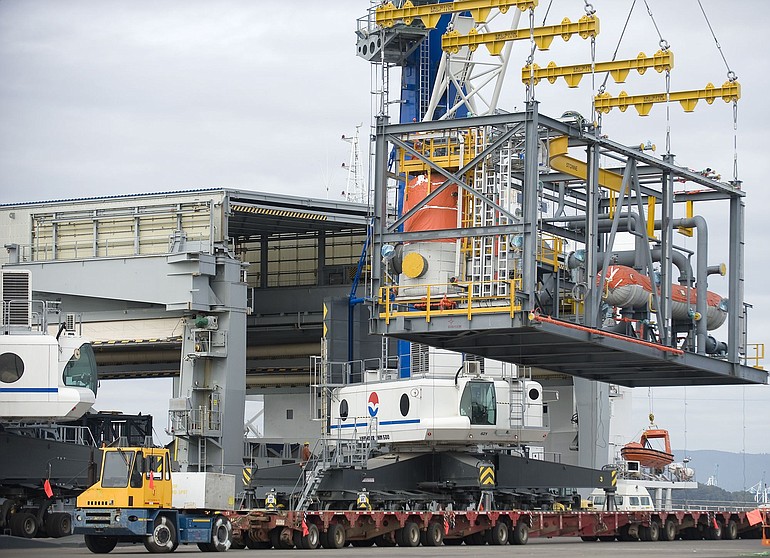Crews at the Port of Vancouver use Liebherr LHM 500 heavy-lift mobile cranes to move an 85-ton oil module out of a ship and onto a truck.
