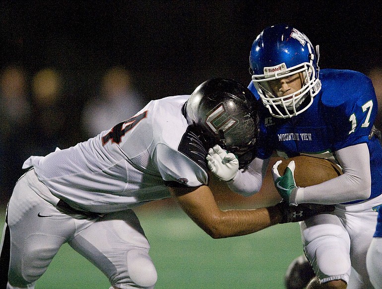 Mountain View's Jeff Carmody takes a hit from Union's Sam Lowe during Week 5 action.