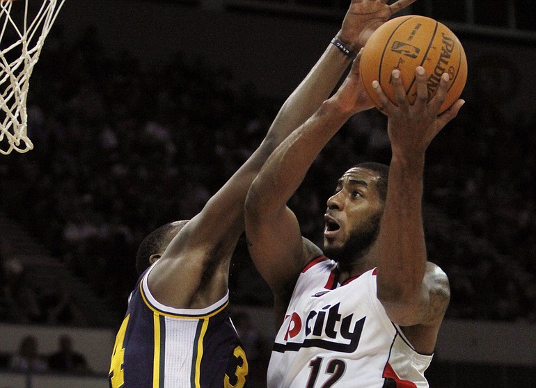 Portland's LaMarcus Aldridge (12) goes to the hoop against Utah's Paul Milsap for two of his game-high 22 points Monday.