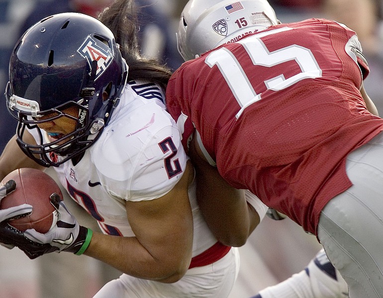 Arizona running back Keola Antolin (2) gets inside Washington State safety Tyree Toomer (15) to score a touchdown during the first quarter Saturday.