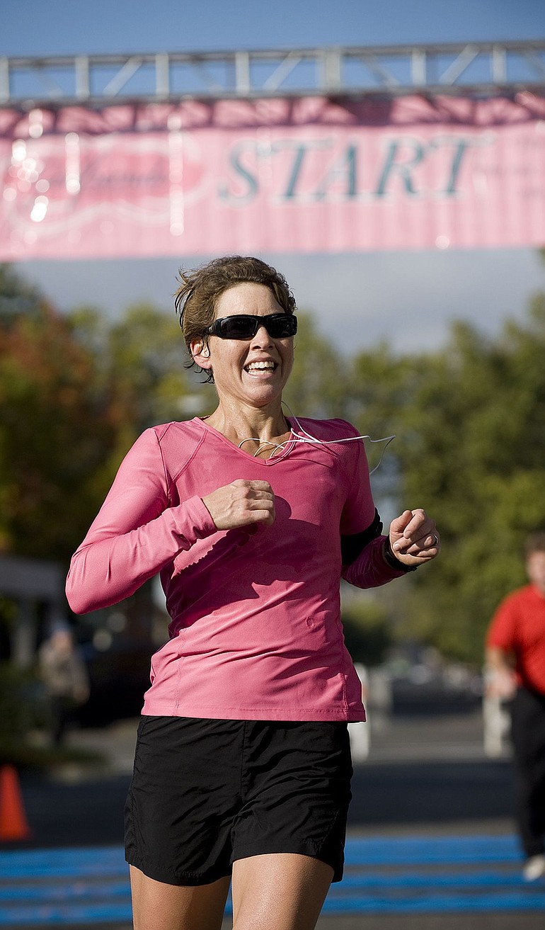 Meg Godfrey, from Lake Oswego, Ore., is the first runner across the finish line at the fourth-annual Girlfriends Half Marathon in Vancouver on Sunday.