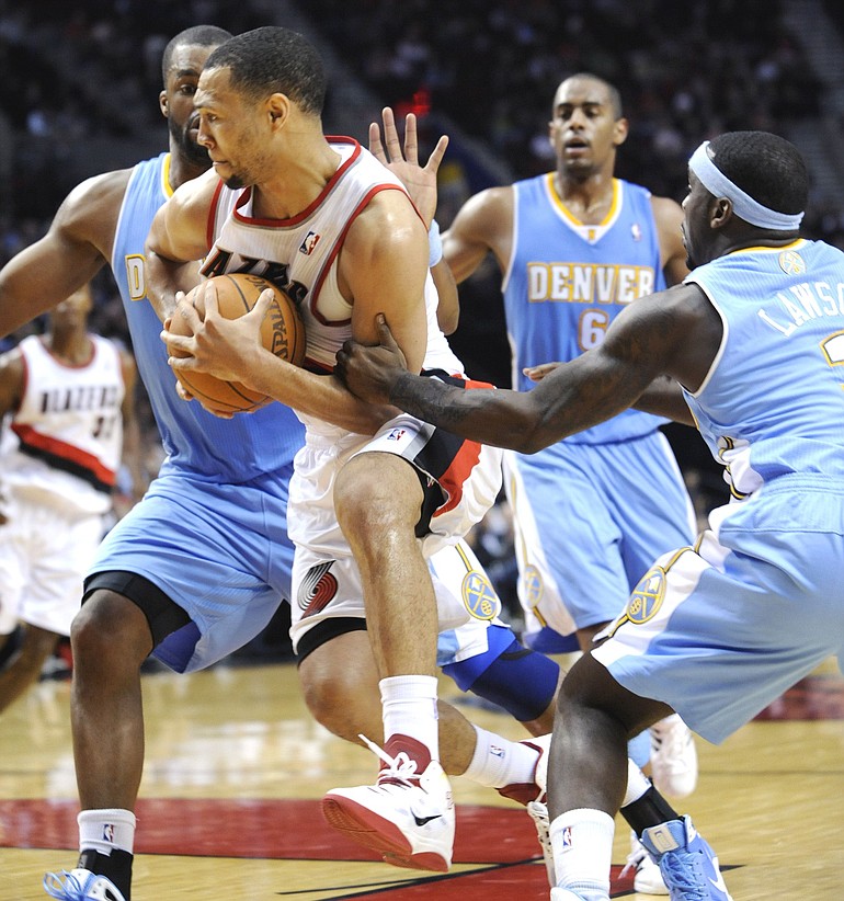 Portland's Brandon Roy (7) is fouled by Denver's Ty Lawson (3) during the second half Thursday.