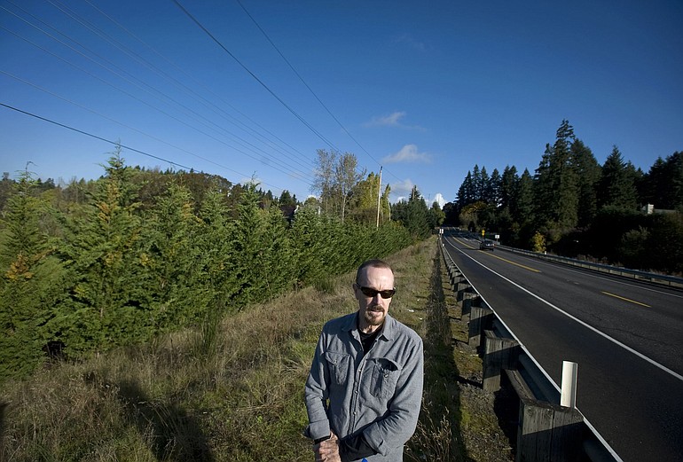 David Leonhardt stands near the a line of cypress trees that he said mysteriously appeared in the spring of 2009.