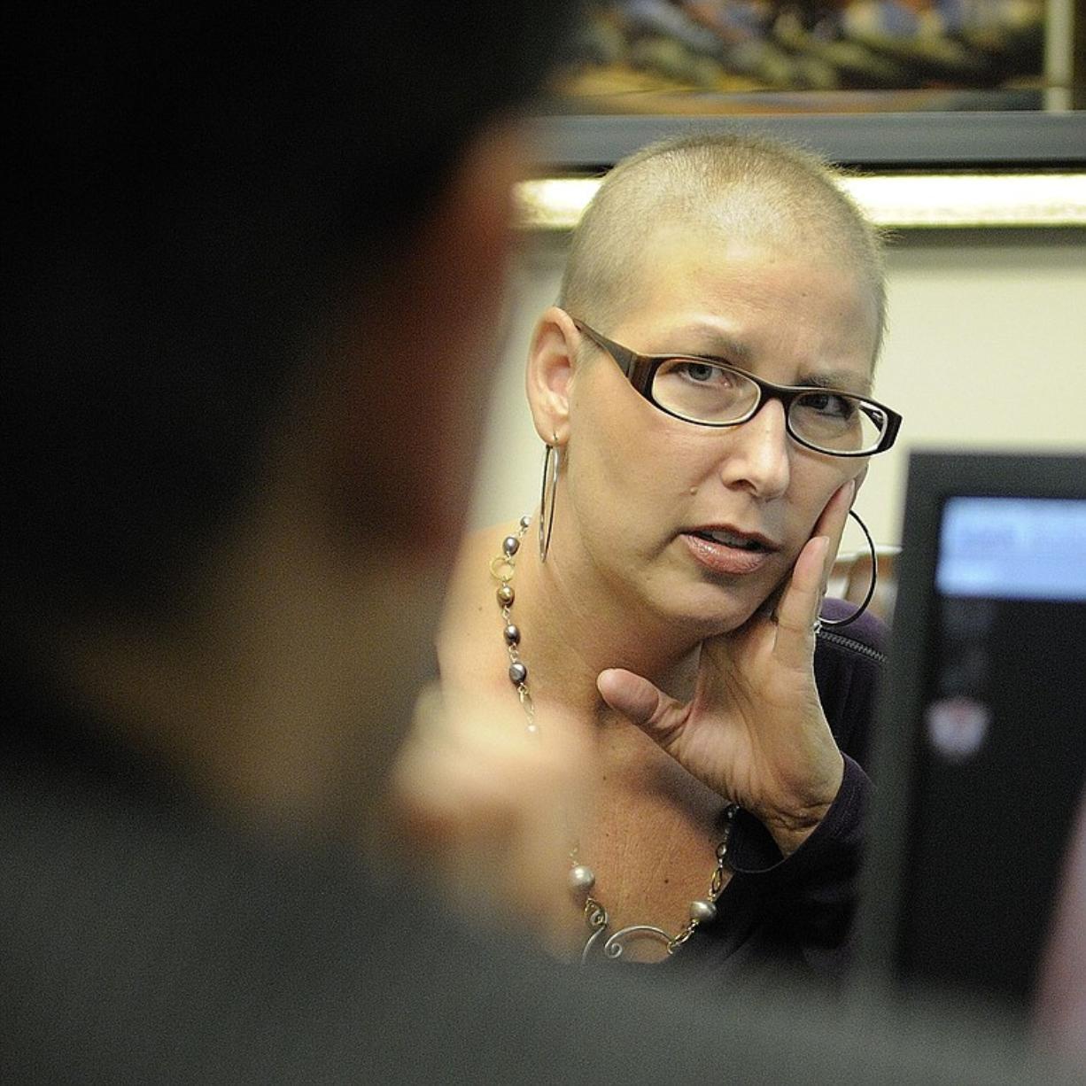 Krista Colvin, a Camas mother of two, listens as Dr.