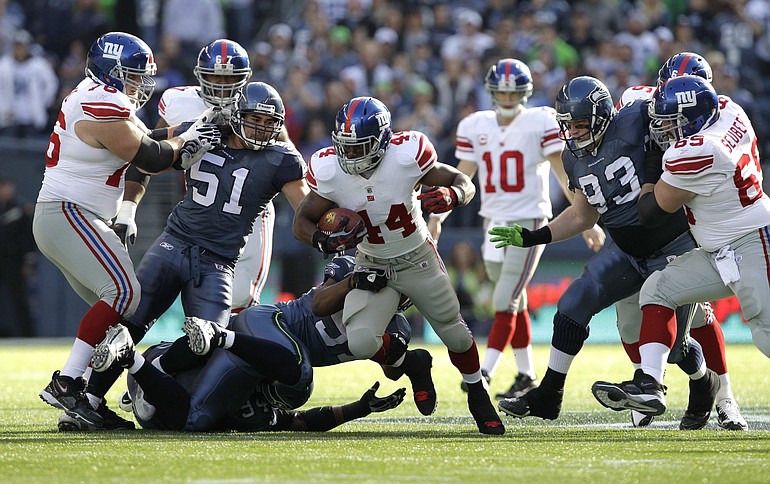 New York Giants running back Ahmad Bradshaw (44) breaks through the middle against the Seattle Seahawks in the first half of Sunday's game at Qwest Field.