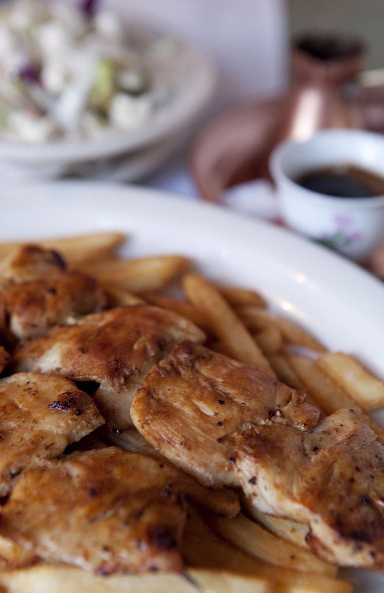 Raznjici, chicken medallions on two skewers with fries, and a green salad is served with Turkish coffee at Bosnia Restaurant in Vancouver.