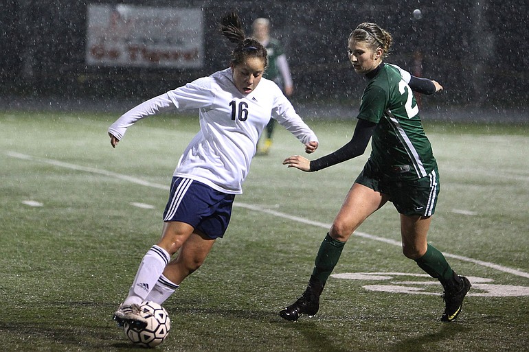 Gabrielle Burrell of Hockinson, left, keeps the ball away from a Sehome High defender during the first round of the Class 2A girls soccer state playoffs at Battle Ground High Schoo.