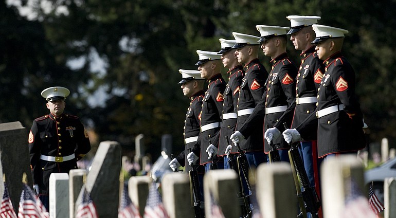 Marines prepare to fire a 21-gun salute during today's Veterans Day observance at Vancouver's historic post cemetery.