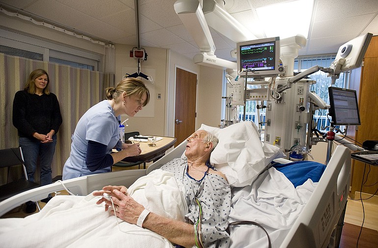 Patient David Hall is cared for by nurse Rebecca Holcomb in the intensive care unit at PeaceHealth's St.