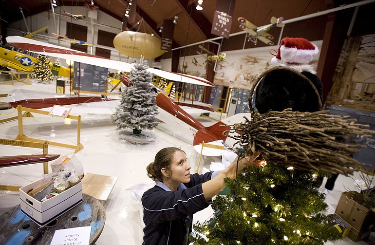 Kristen Curry of Washougal works on the &quot;Christmas in the Woods&quot; themed tree.