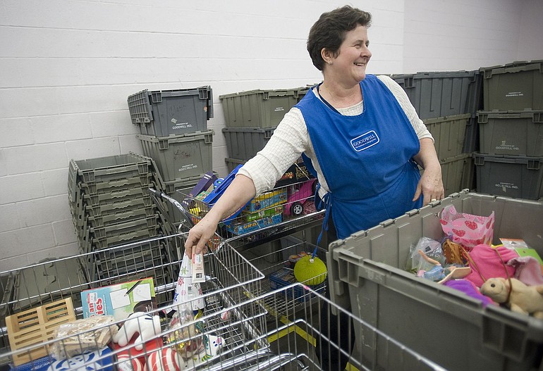 Dervisa Colakovic, 54, sorts donations Friday at the Goodwill Industries store in Fisher's Landing.