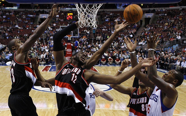 Portland Trail Blazers' Dante Cunningham, from left, LaMarcus Aldridge and Nicolas Batum battle for a rebound against Philadelphia 76ers' Marreese Speights, right, in the first half of an NBA basketball game, Tuesday, Nov. 30, 2010, in Philadelphia.