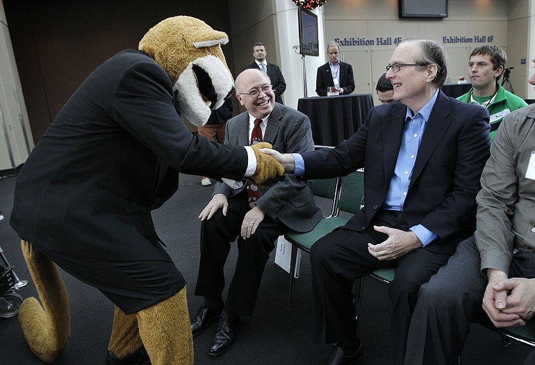 Paul Allen is greeted by Washington State University mascot Butch as campaign chairman Scott Carson looks on at a fundraising kick-off for Washington State University on Thursday in Seattle.