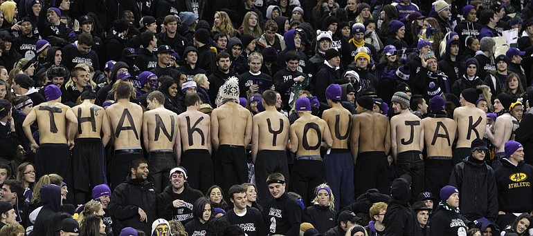 Fans of Washington quarterback Jake Locker spell out their appreciation of him on their backs from the bleachers at Husky Stadium.