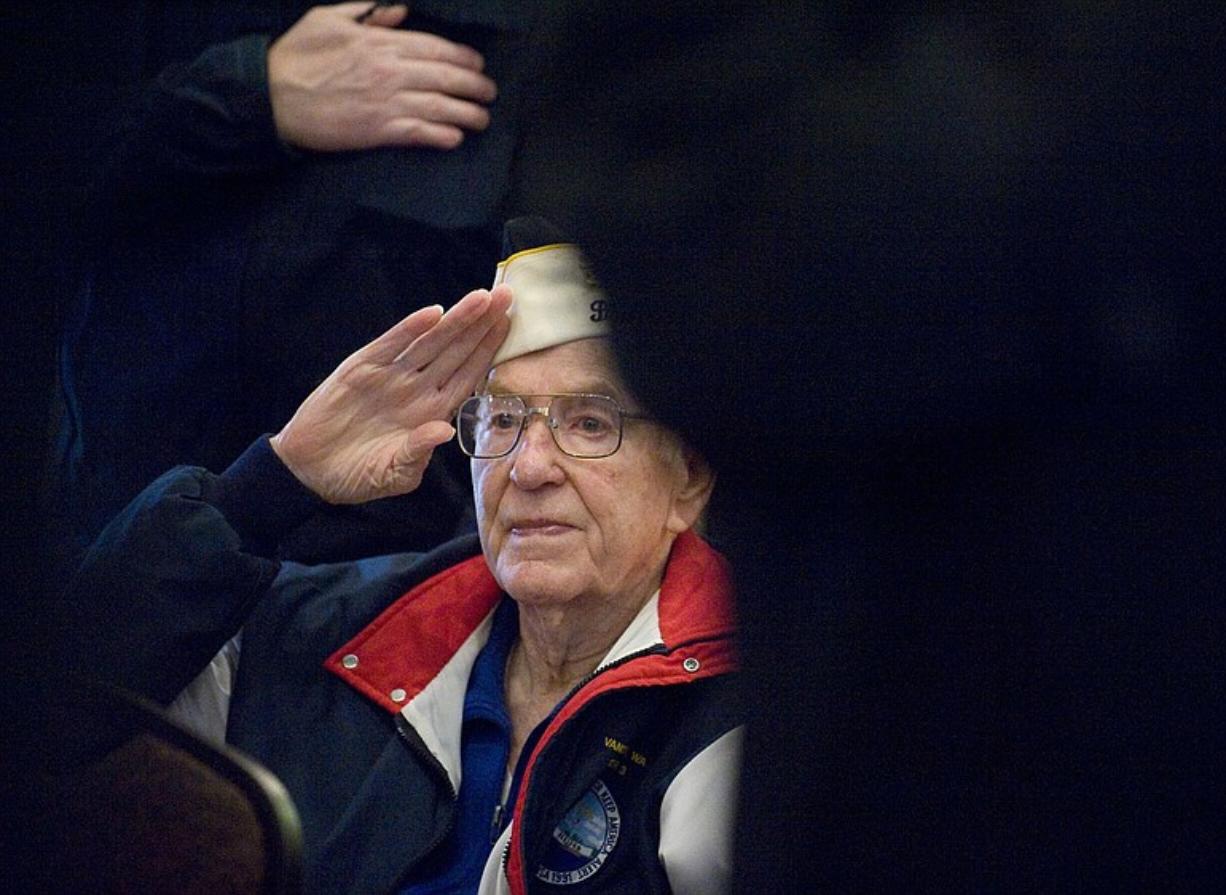 Pearl Harbor survivor Bernard DeGrave of Vancouver salutes during the singing of the national anthem at Tuesday's annual observance of the Pearl Harbor attack. DeGrave was aboard the USS Montgomery, which headed out on patrol barely two hours after the attack started on Dec.