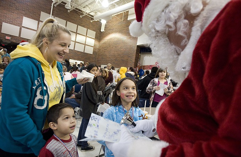 The Barbosas -- mom Lilly, from left, Nicholas, 3, and Aliyana, 8 -- meet Santa at the Community Youth Holiday Event at Sarah J.