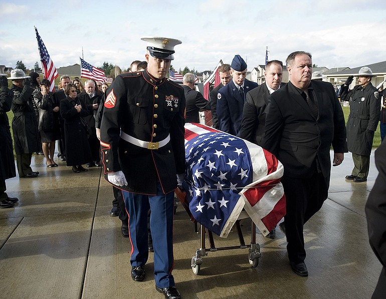 The body of Marine Sgt. Jason D. Peto is escorted Saturday into Holy Redeemer Catholic Church in Vancouver. Sgt.