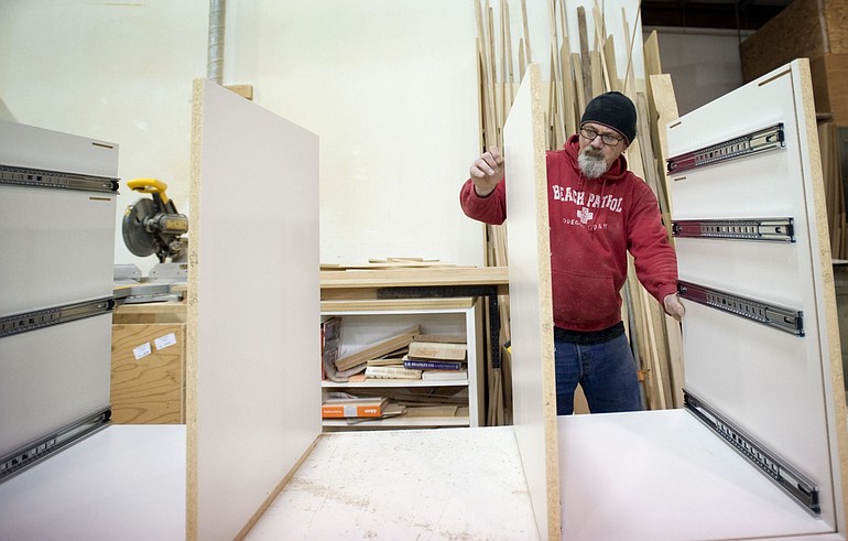 Nick Suver assembles cabinetry at Cabinet Designs Unlimited in Camas.