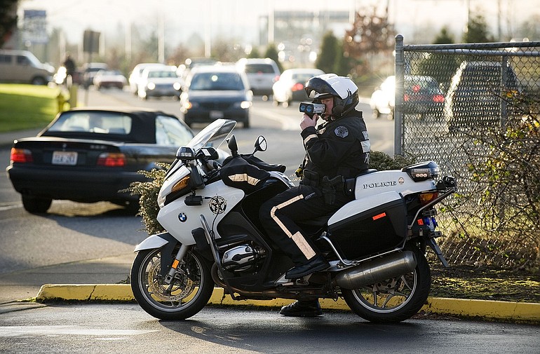 Vancouver police Officer John Davis watches for speeders on Northeast Vancouver Plaza Drive earlier this week.